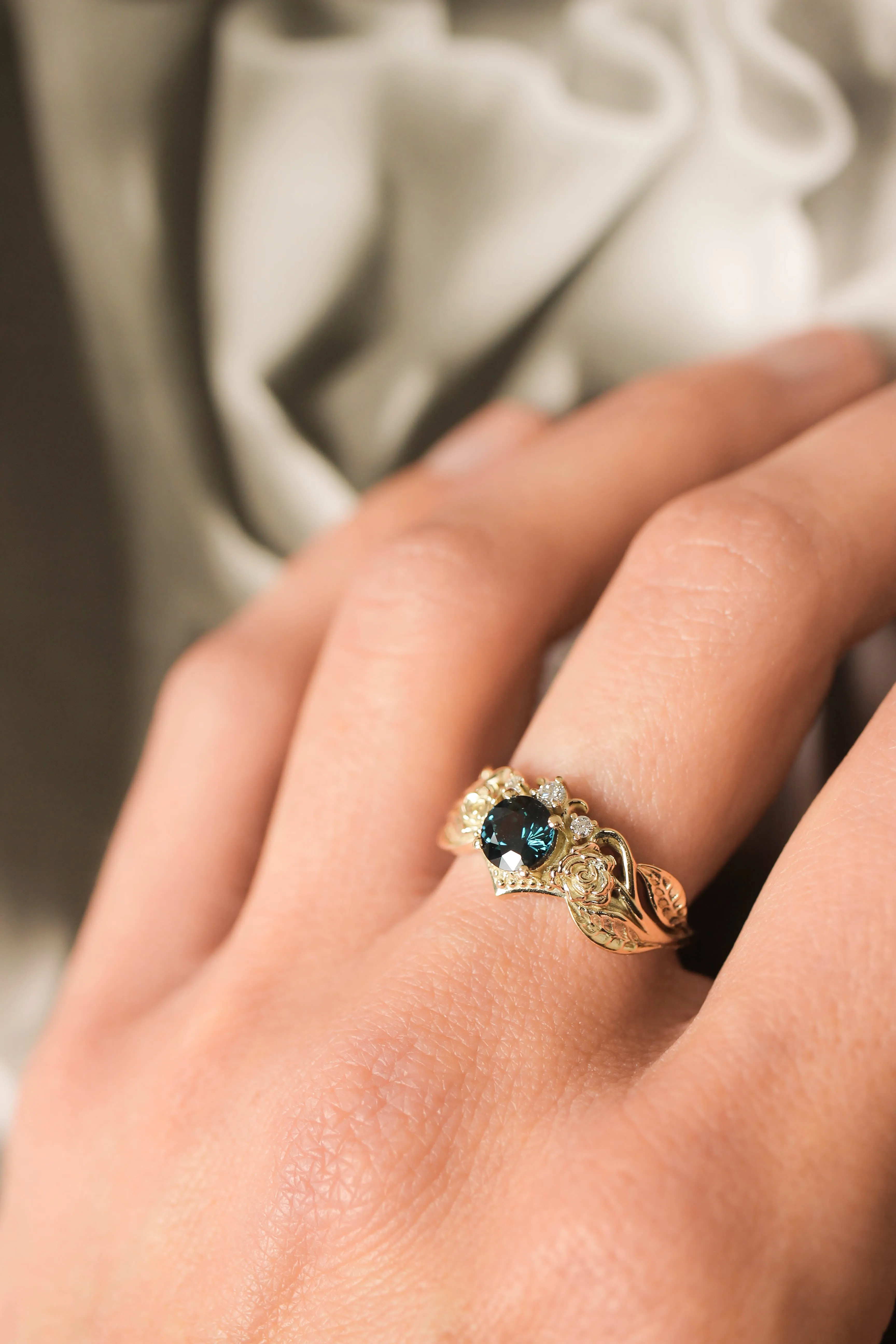 Engagement ring with two roses, sapphire and diamonds