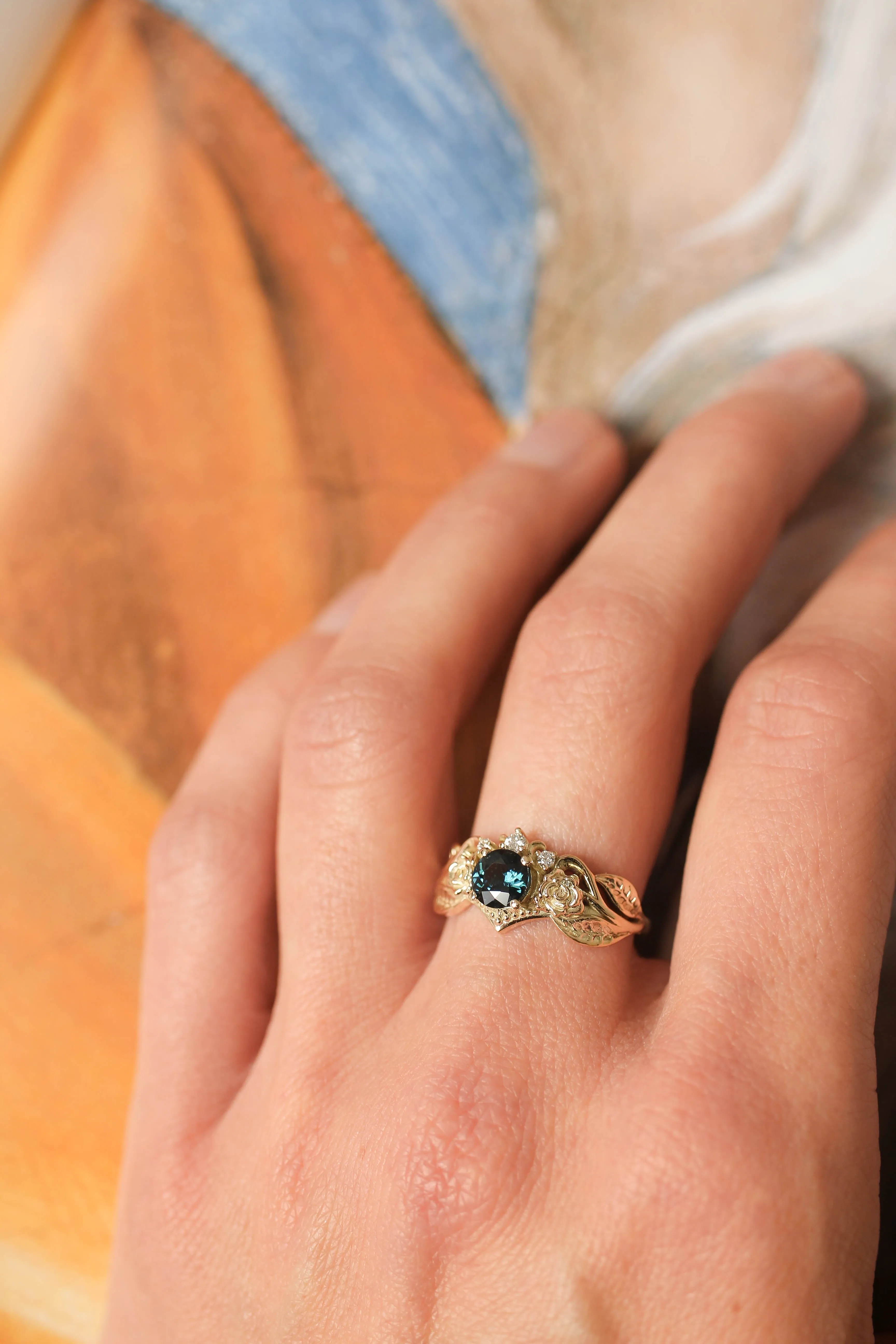 Engagement ring with two roses, sapphire and diamonds